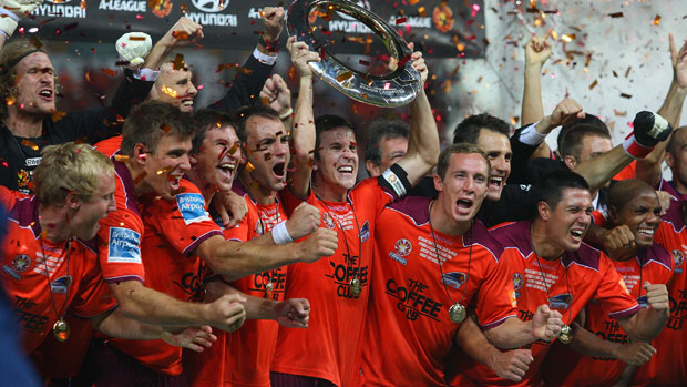 Brisbane Roar skipper Matt McKay gets his hands on the A-League trophy after their incredible comeback win in the 2011 decider.